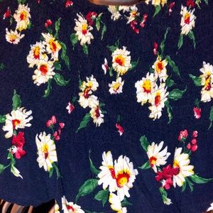 Crop top. Navy blue. Floral design. Stretchy. Goes over or around the shoulders.